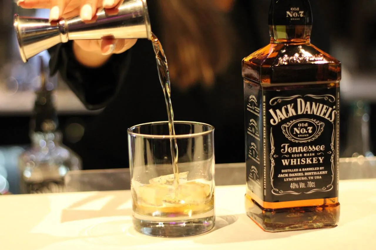 Whiskey being poured into a glass at the Rendezvous bar