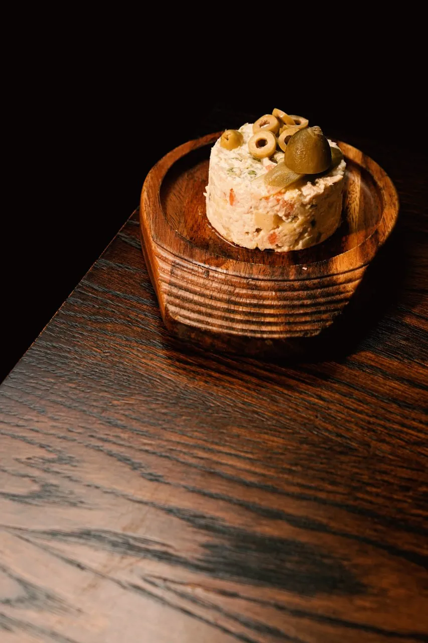 A savoury olive starter served on a wooden dish